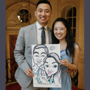 Couple at a wedding getting a caricature
